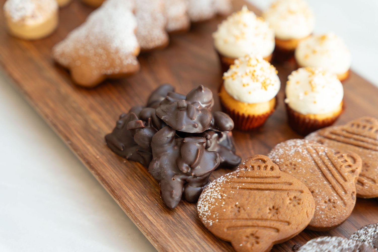 Gourmet dessert board with chocolate-dipped cookies and decorated pastries.