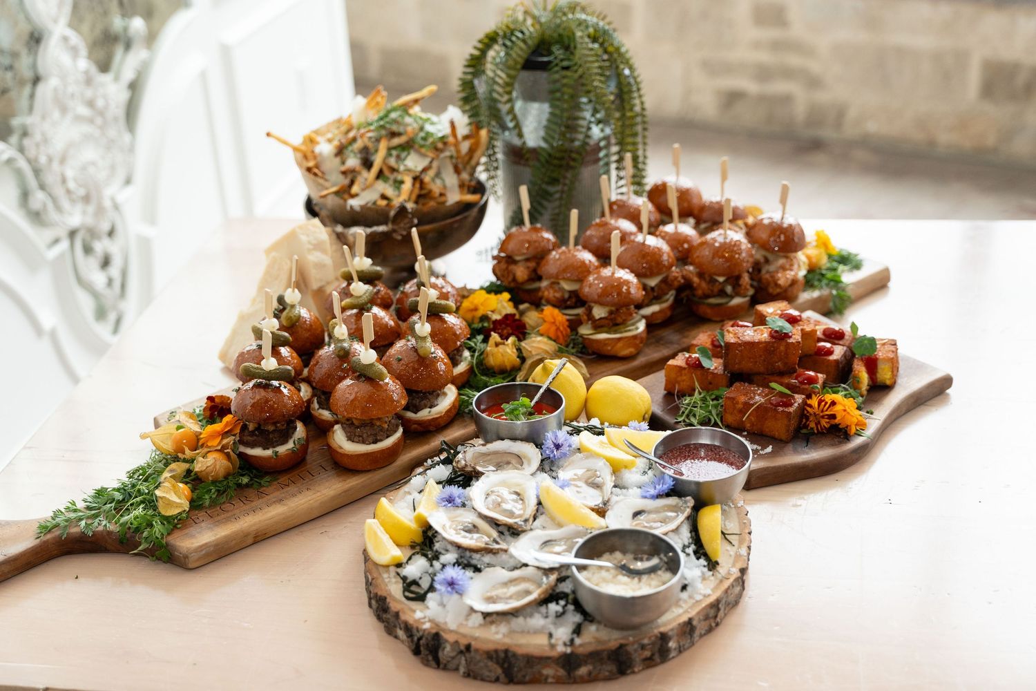Seafood platter with fresh oysters, appetizers and garnishes arranged on wooden serving boards.