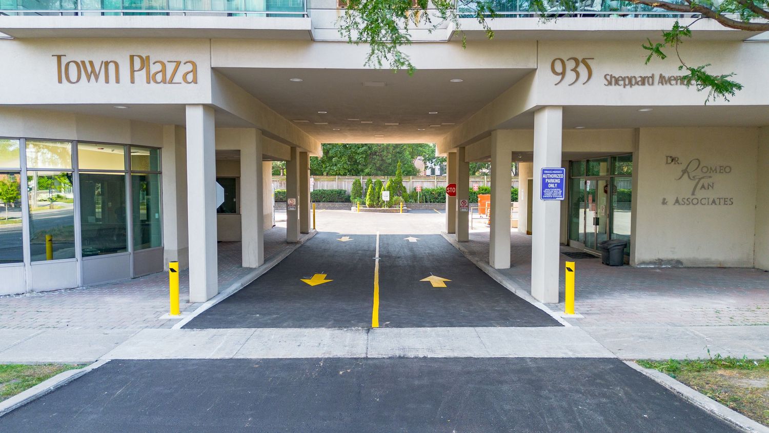 Entrance to a parking garage showing multiple bays and yellow safety markings on the ground.