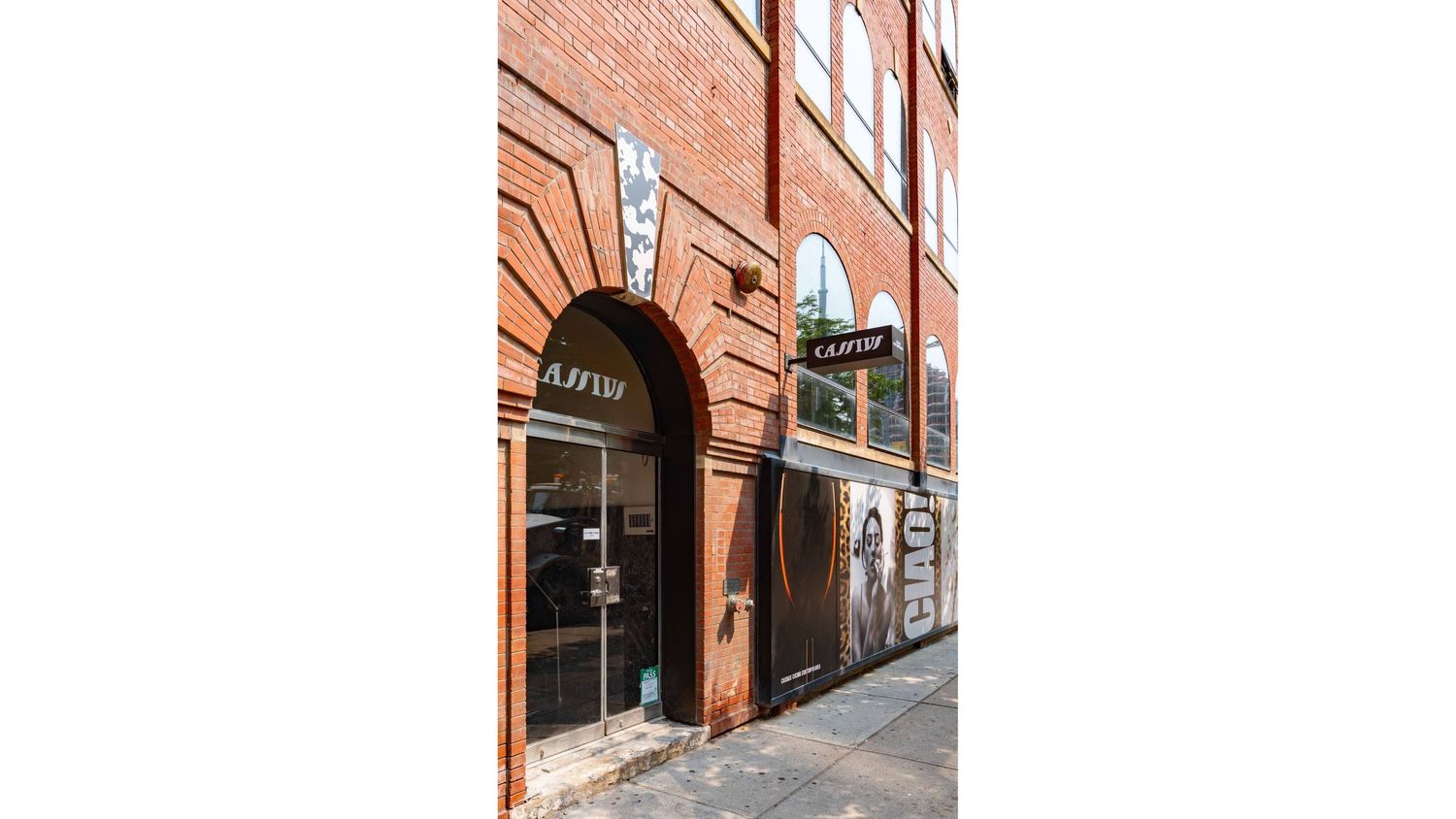 Red brick exterior of Cassius On King with large windows and architectural details.