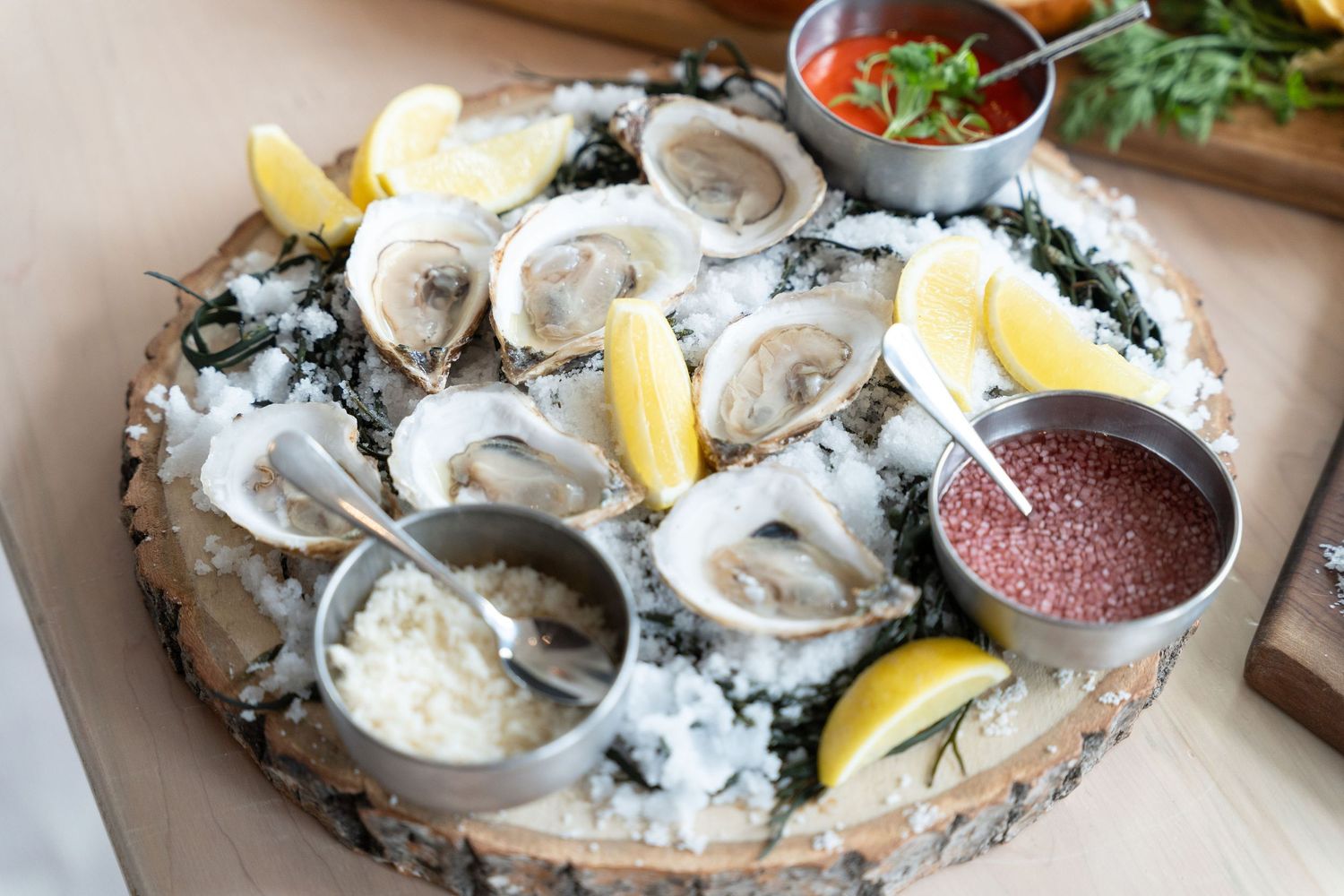 Fresh oysters on the half shell served with lemon wedges and mignonette sauce on crushed ice.