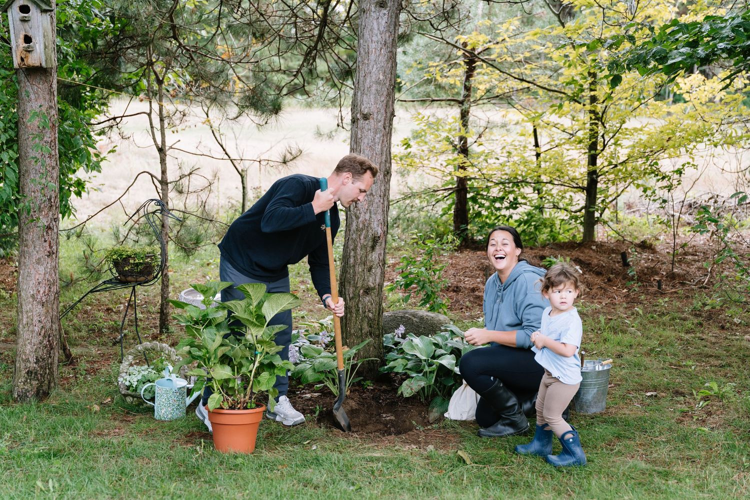 A series of outdoor nature scenes showing people interacting in a wooded garden setting.