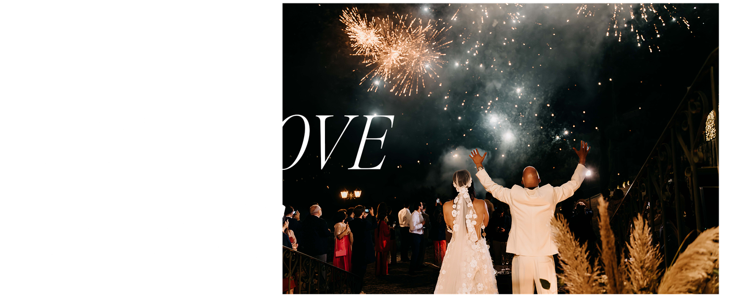 A newlywed couple shares their first dance outdoors under glowing sparklers and fireworks during an evening celebration.