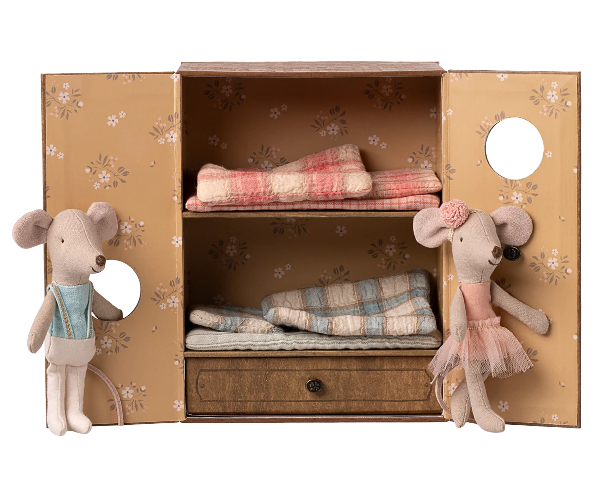 A series of vintage-style photos showing plush mice toys arranged in decorative wooden boxes with soft fabrics and ribbons.