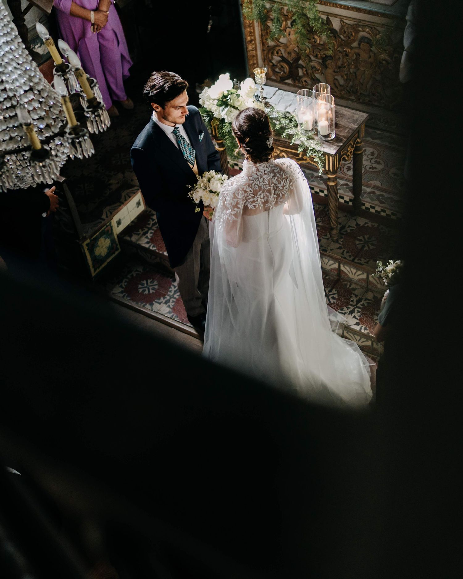 A moody wedding photography sequence showing the back of a bride in a white dress at a dimly lit venue.