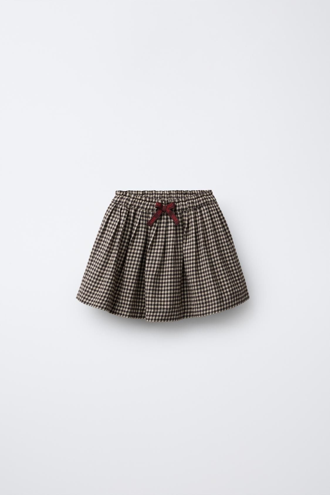 Brown and beige houndstooth check pattern pleated mini skirt with elastic waistband shown from five different angles.