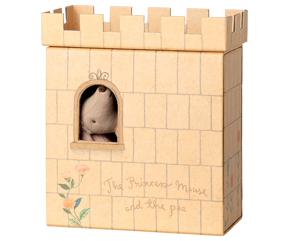 A brown cardboard castle with a window cutout and crenellated battlements sits against a white background.
