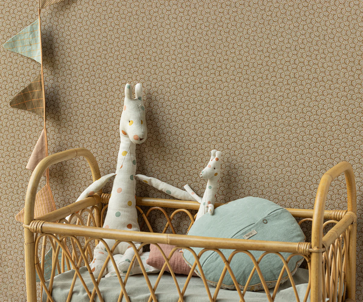 A decorative rattan or wicker headboard with curved lattice pattern against a beige textured wall.