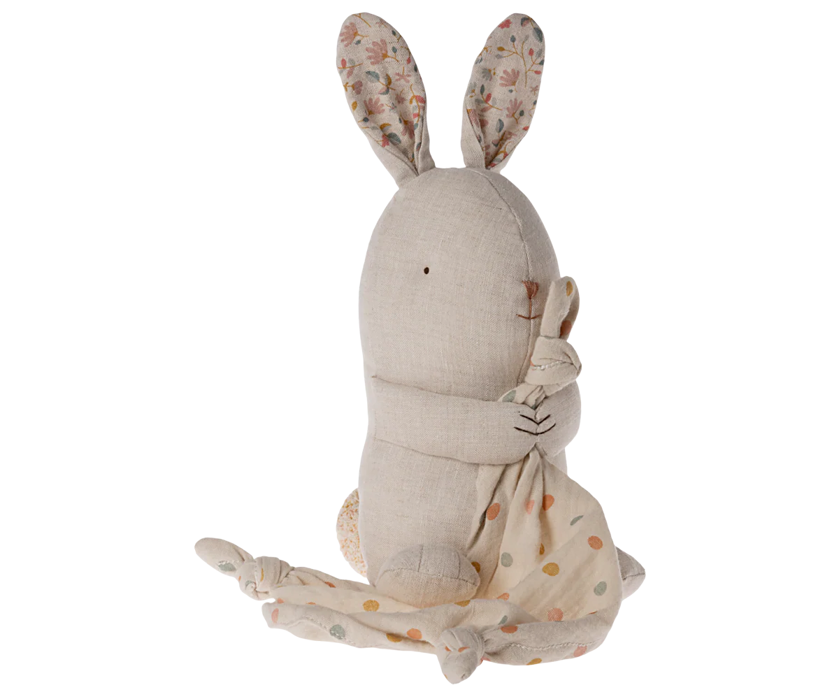 Plush stuffed bunny rabbit toy with floral pattern ears and soft beige fabric shown from behind.