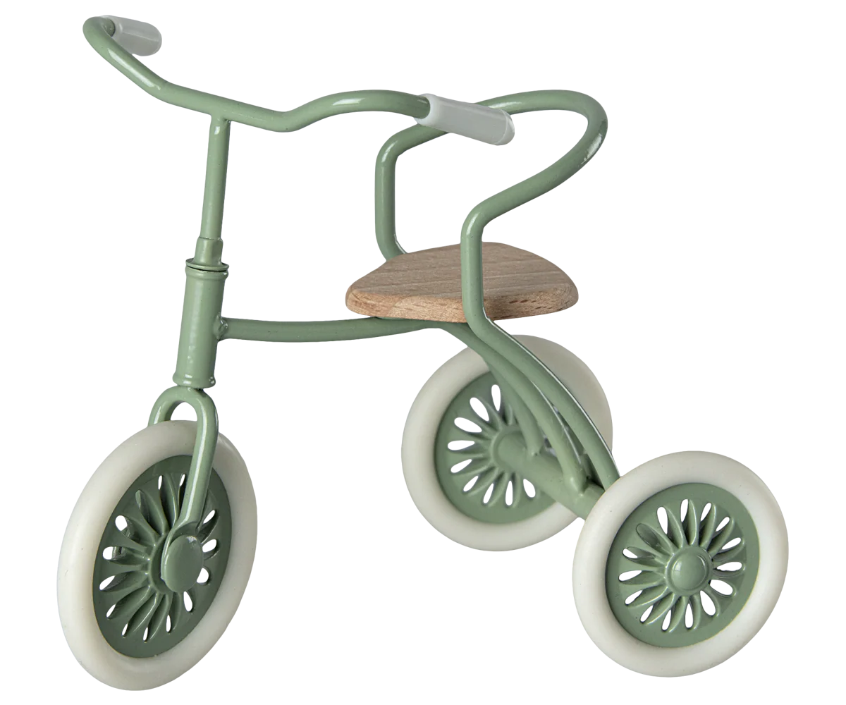 Vintage mint green tricycle with wooden seat and three white wheels featuring decorative spoke patterns.