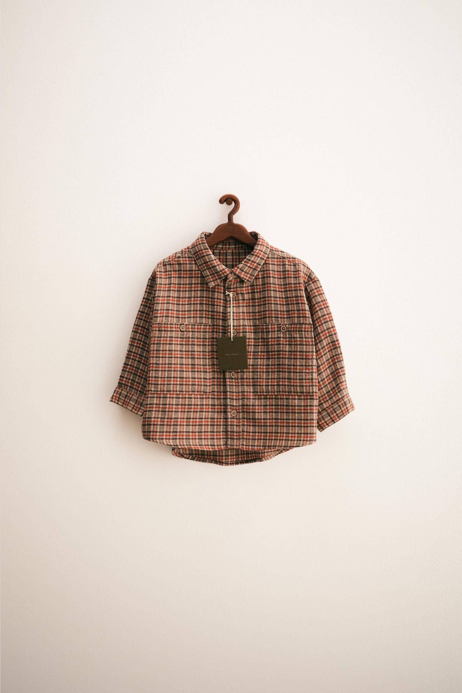 Short sleeved plaid button-up shirt shown in five different product photos against white background.