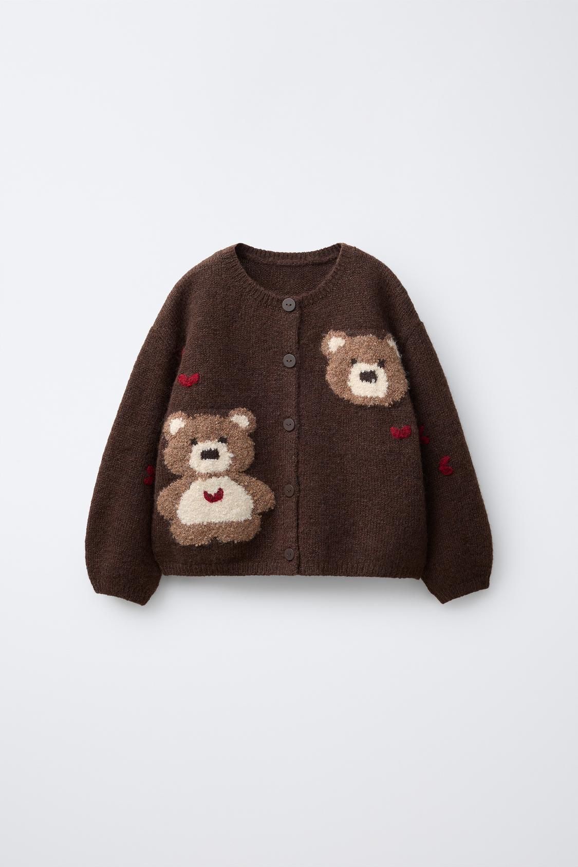 Cute brown knit baby cardigan sweater with teddy bear design and button closure.