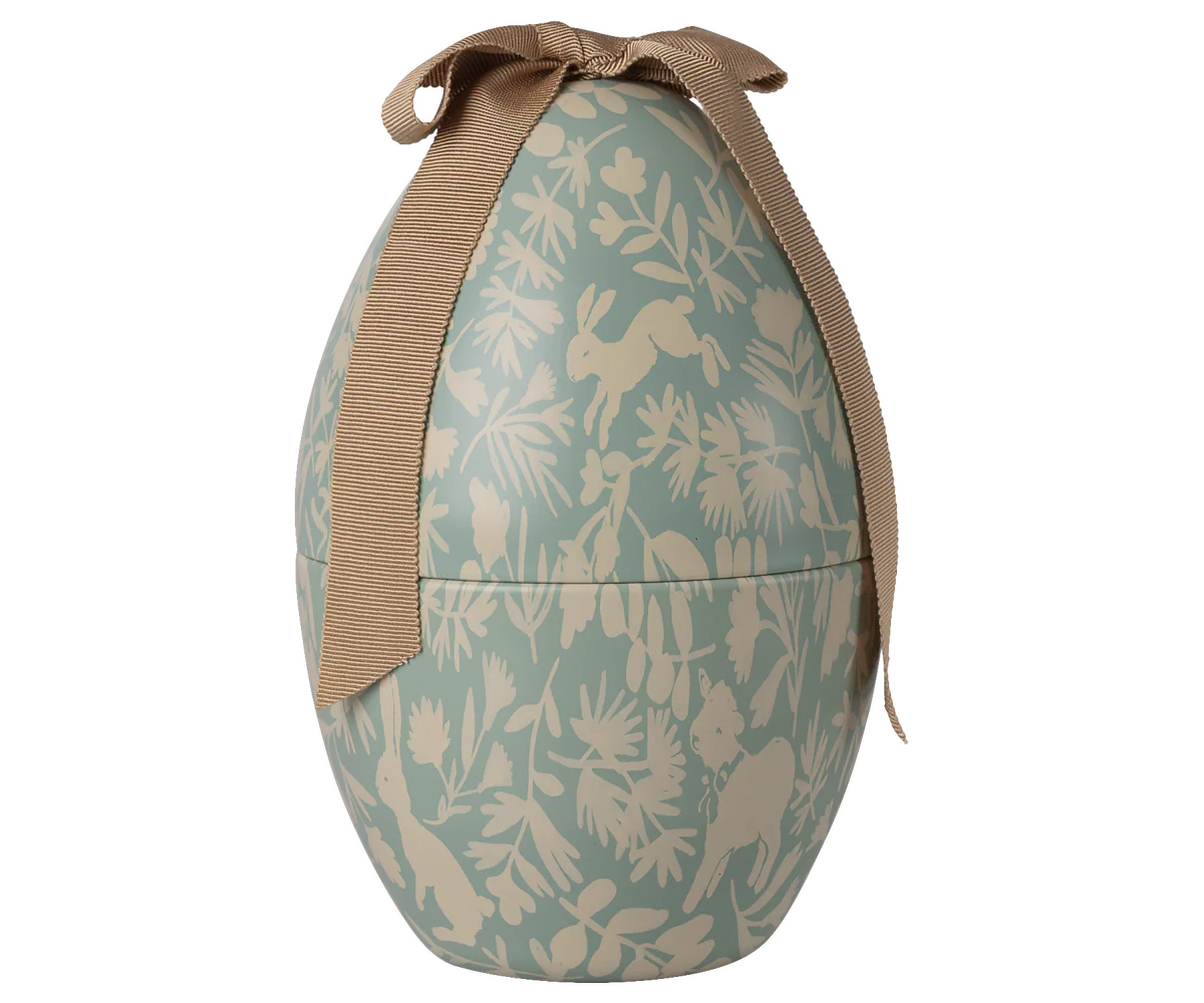 Four views of a light blue and beige floral patterned backpack with tan straps shown from different angles.