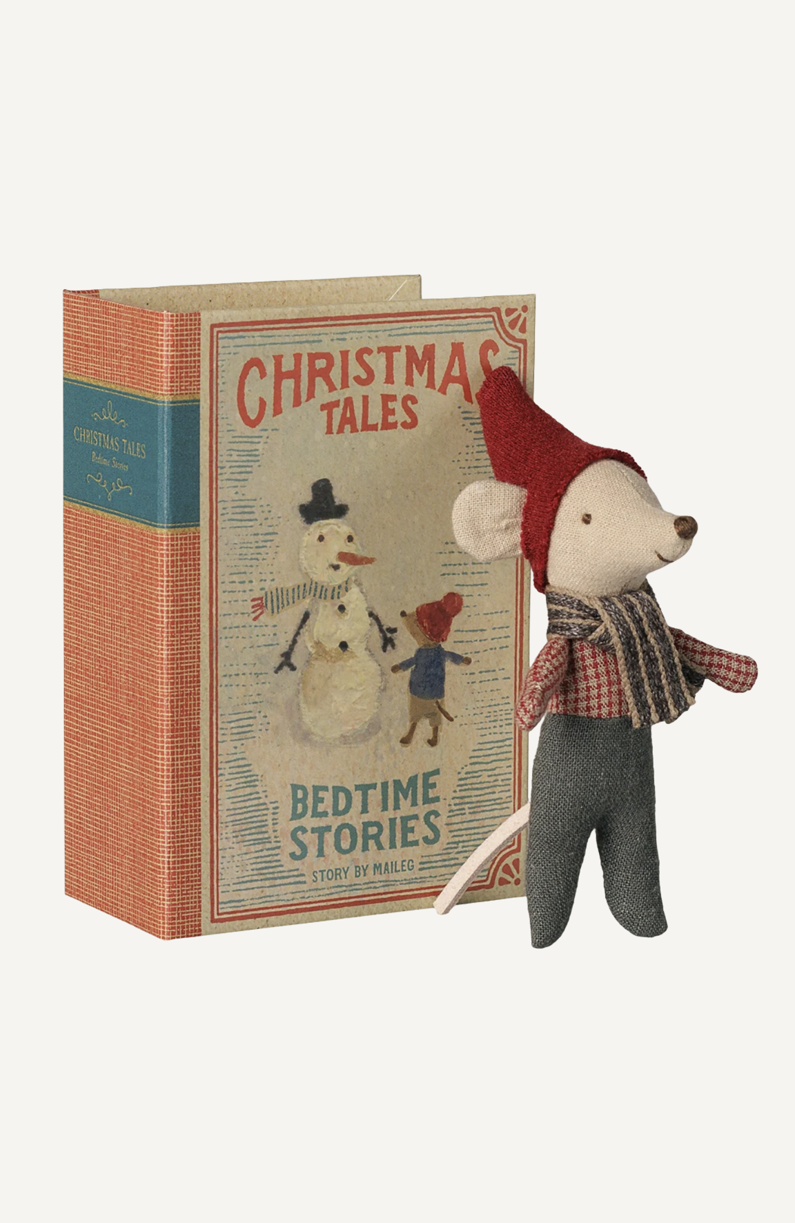 Maileg Christmas mouse toy in red hat and plaid scarf beside a Christmas Tales Bedtime Stories book box.