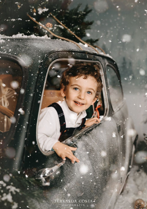 Vintage car in snowy winter scene with falling snowflakes.