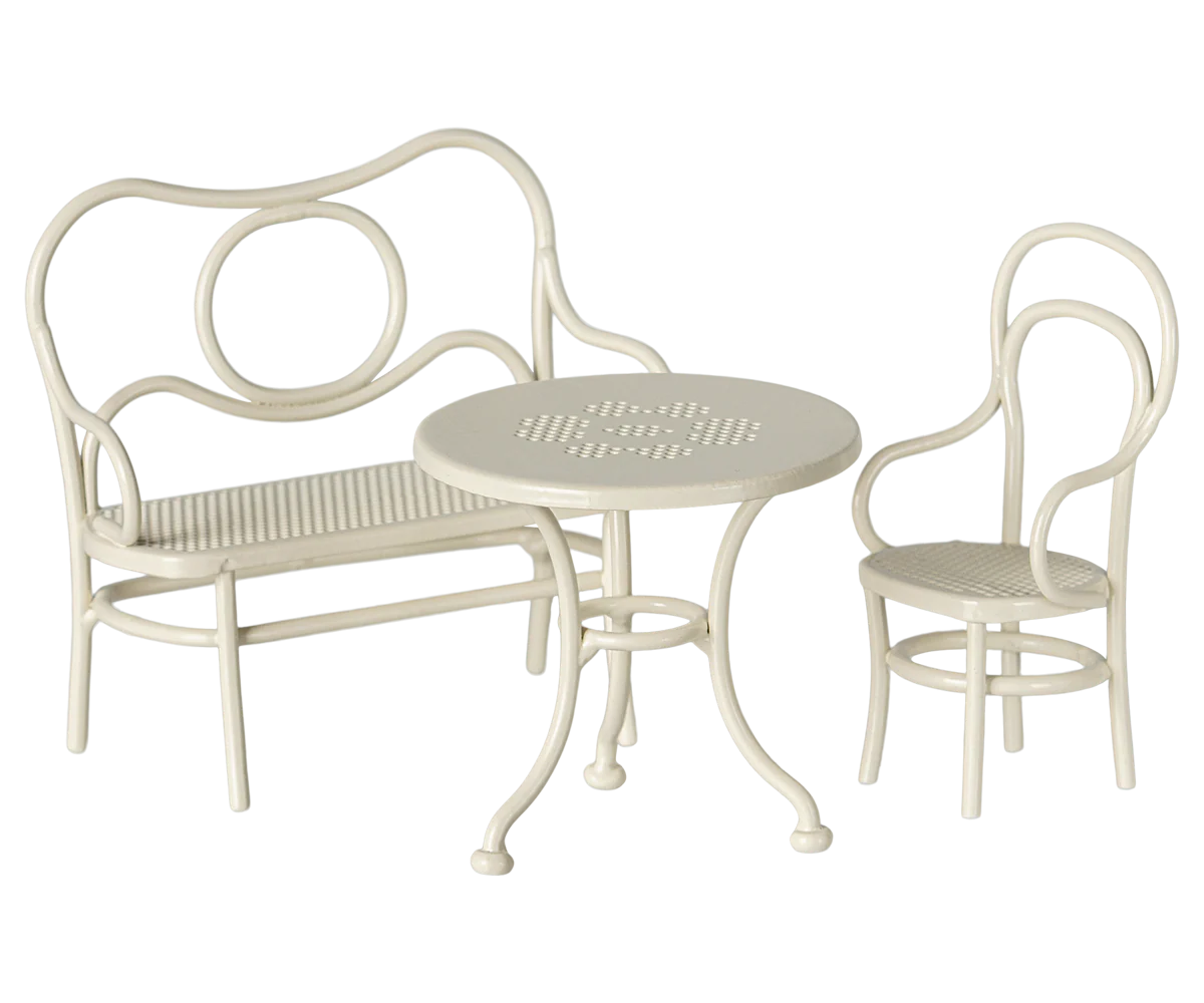 A row of white bentwood dining chairs with curved backs and woven seats arranged in a line against a white background.