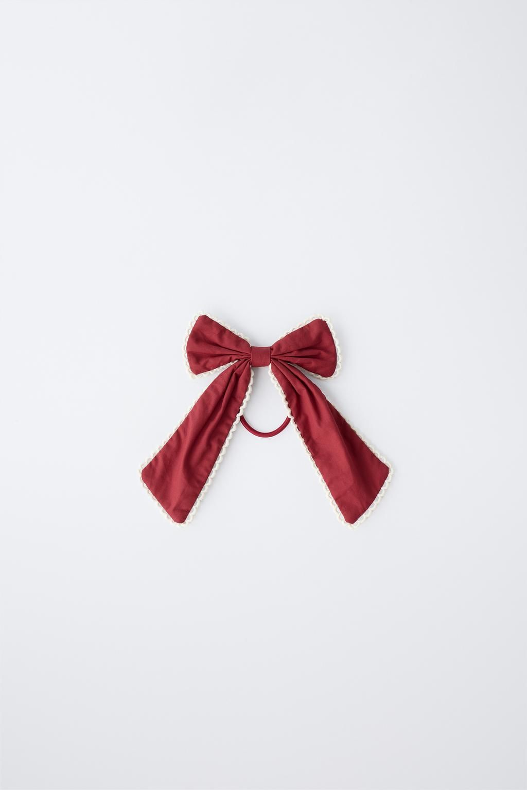 Four red silk bow ties arranged in a horizontal line against a white background, showing different bow sizes and styles.