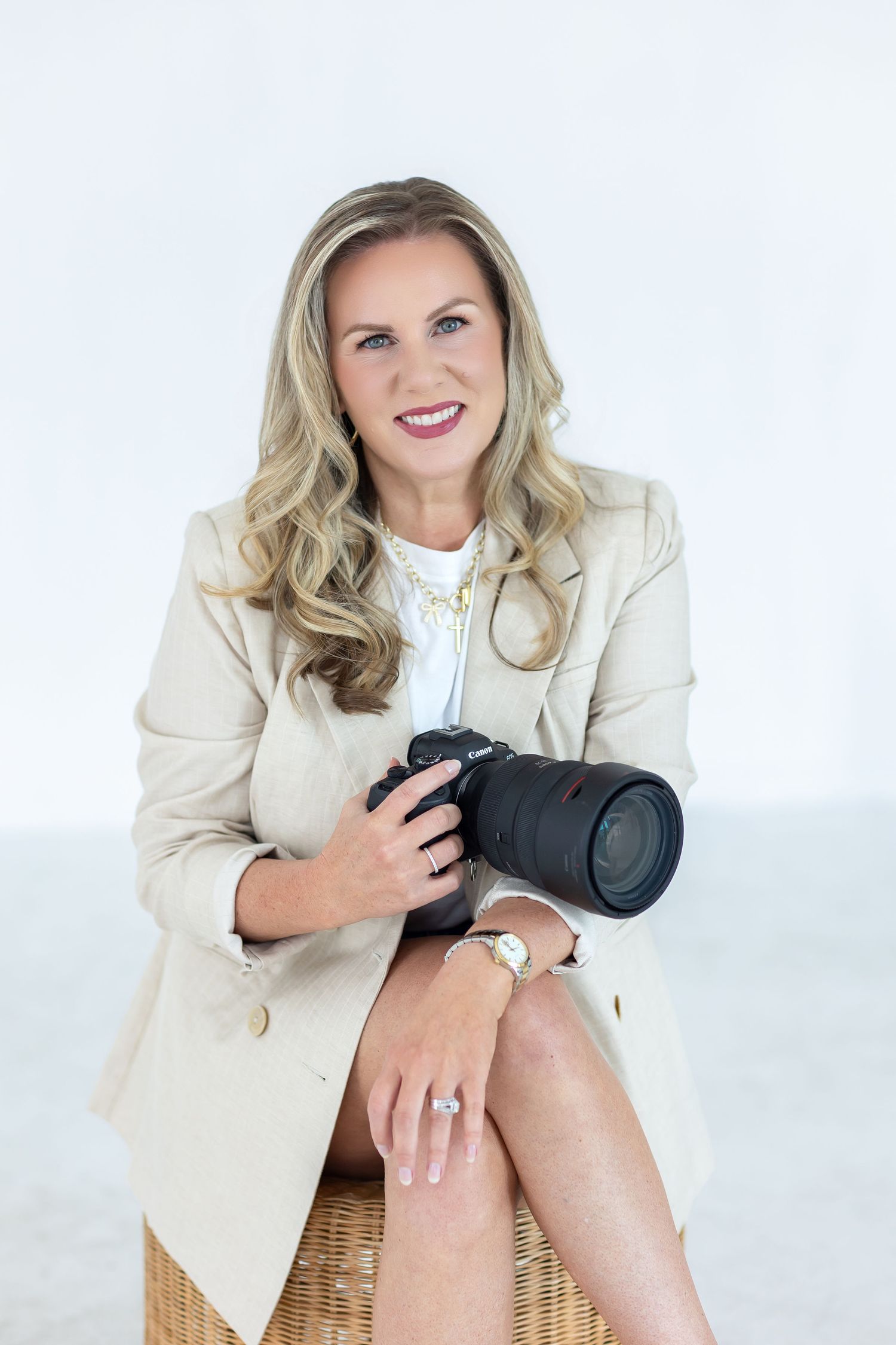 Carla Collins, Houston senior photographer and motherhood photographer, holding a Canon camera during a branding session.