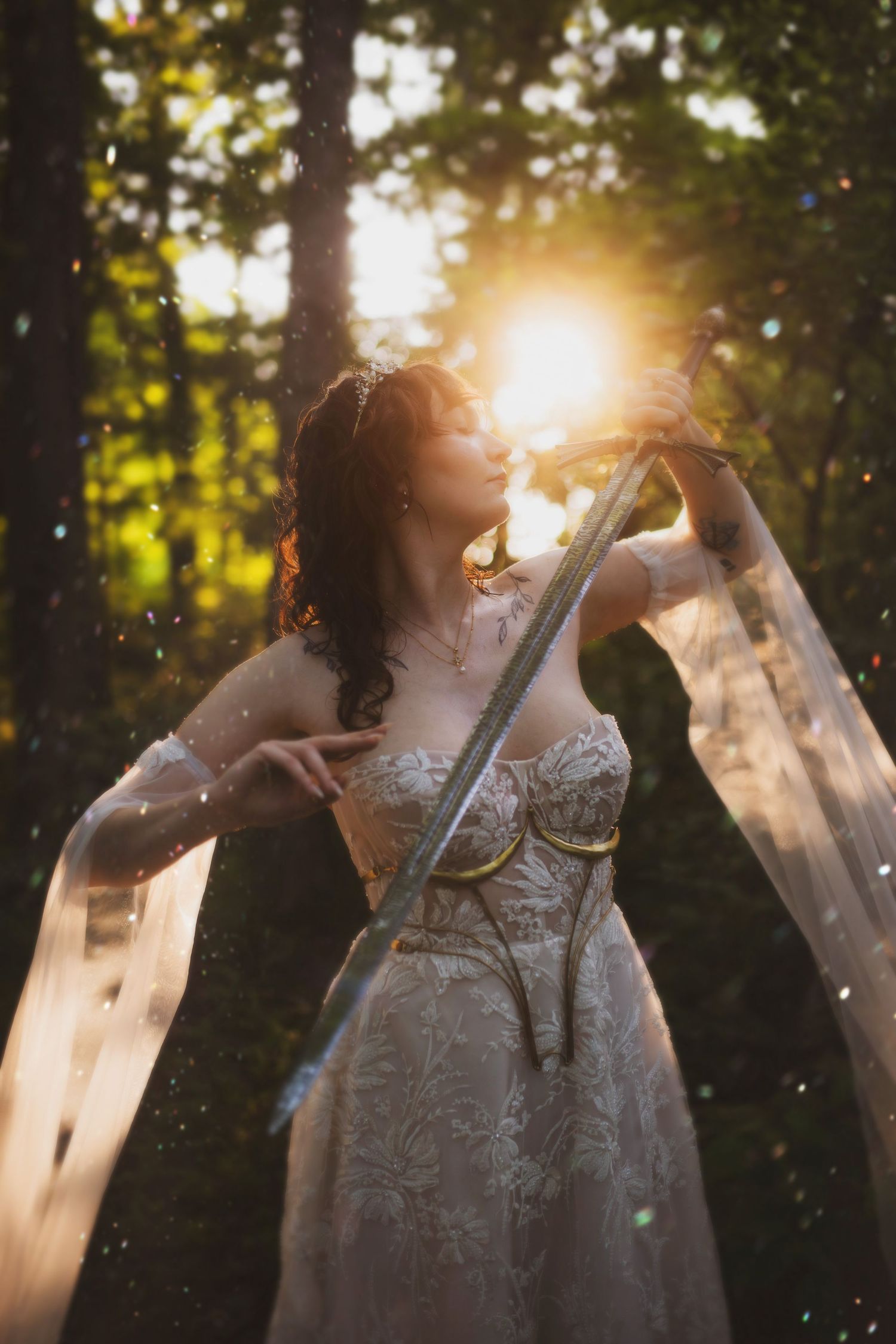 A person in a white lace dress twirls in a sun-dappled forest during golden hour creating a dreamy ethereal effect.