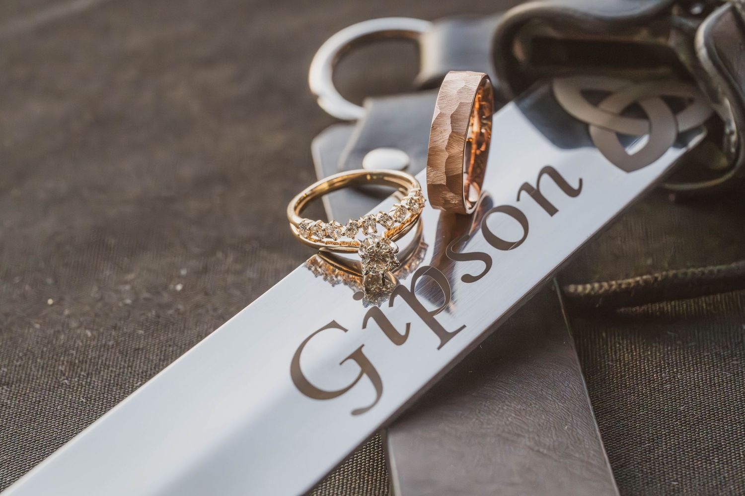 A diamond engagement ring rests on a white Gibson guitar case label with elegant lettering.