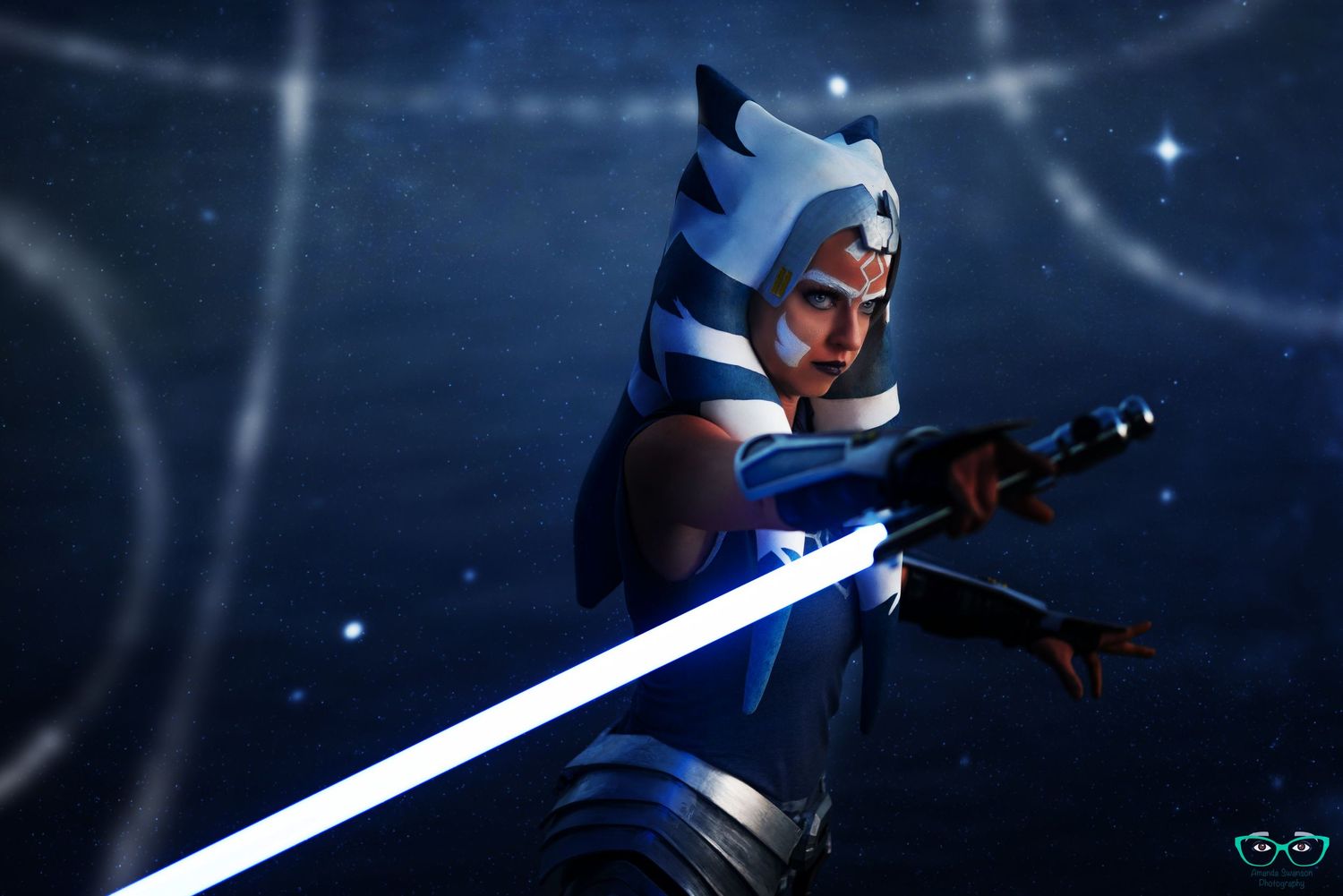 A Star Wars character with blue and white armor wields a glowing lightsaber in a dark atmospheric setting.
