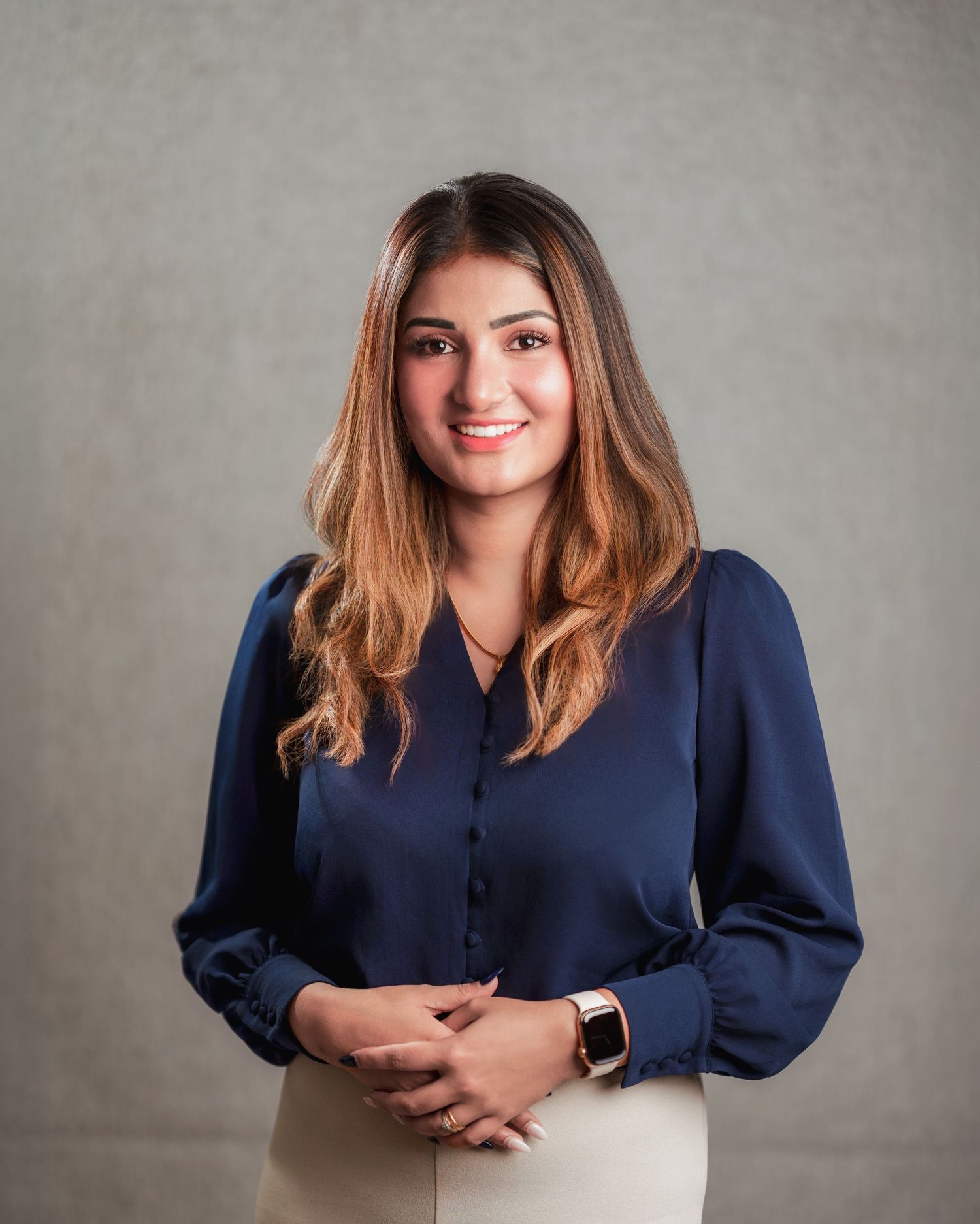 Professional business portrait series showing person in navy blazer against grey backdrop.
