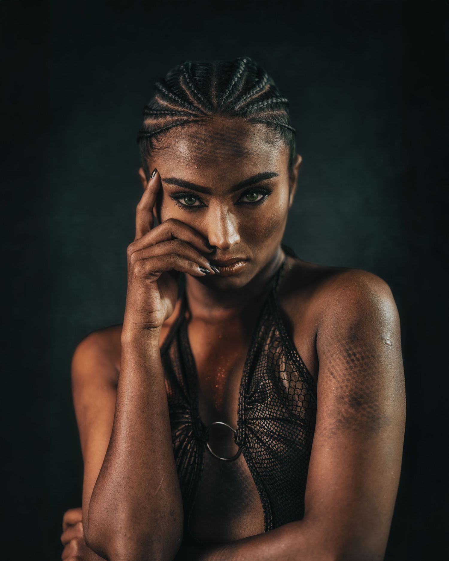 Dramatic close-up portraits showcasing intricate braids and expressive poses.