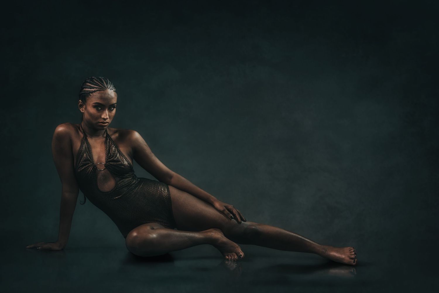 Artistic fashion series featuring elegant reclining poses in low light.