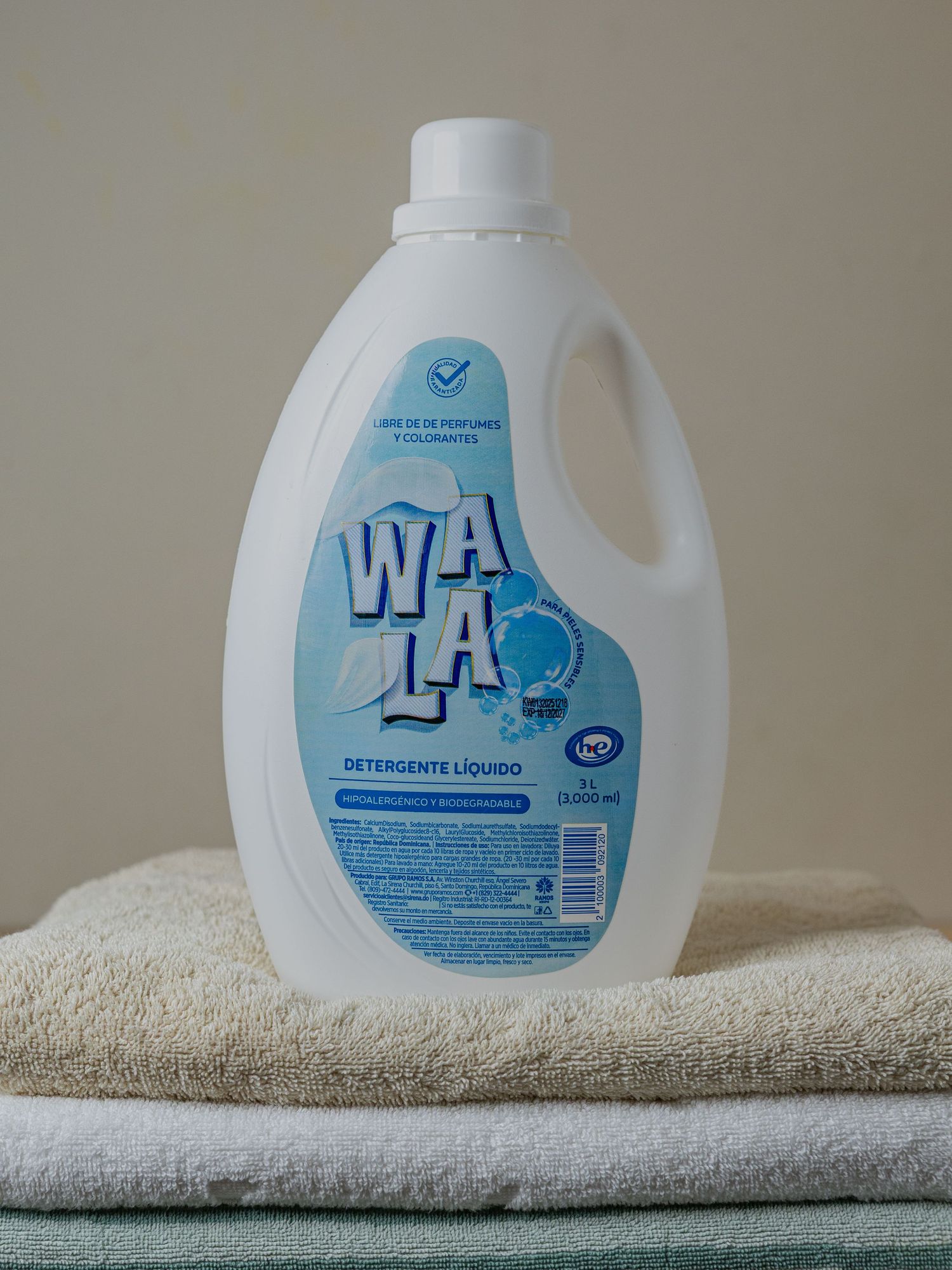 Wala liquid detergent bottle placed on folded towels, a fragrance-free laundry soap for clean clothes.