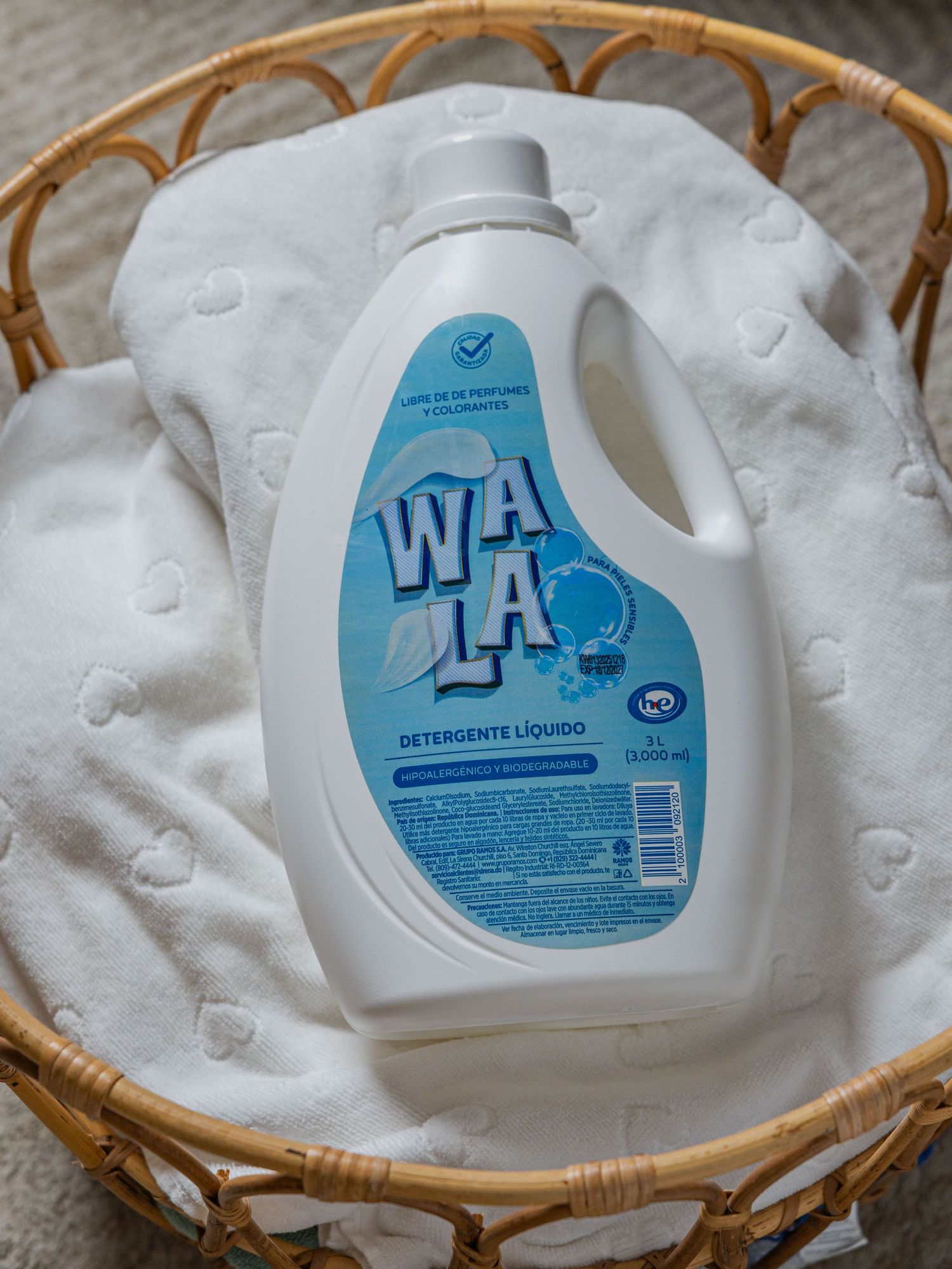 WALA liquid detergent bottle in a wicker basket with white fabric, fragrance and colorant free formula.