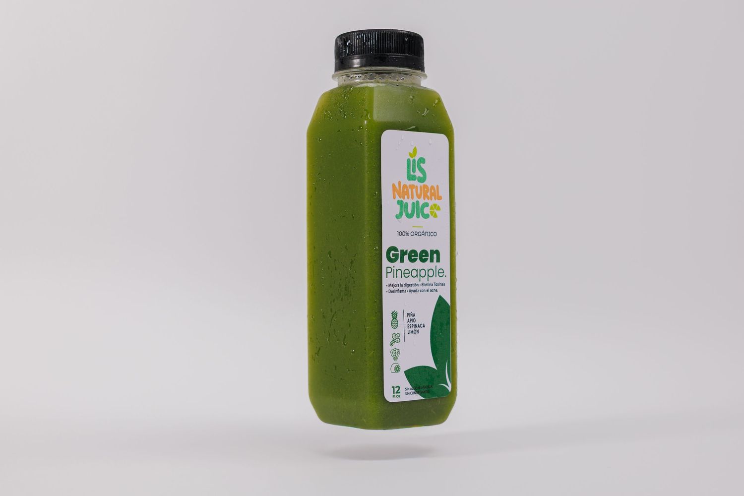 A bottle of green pineapple juice with a black cap and branded label on a white background.