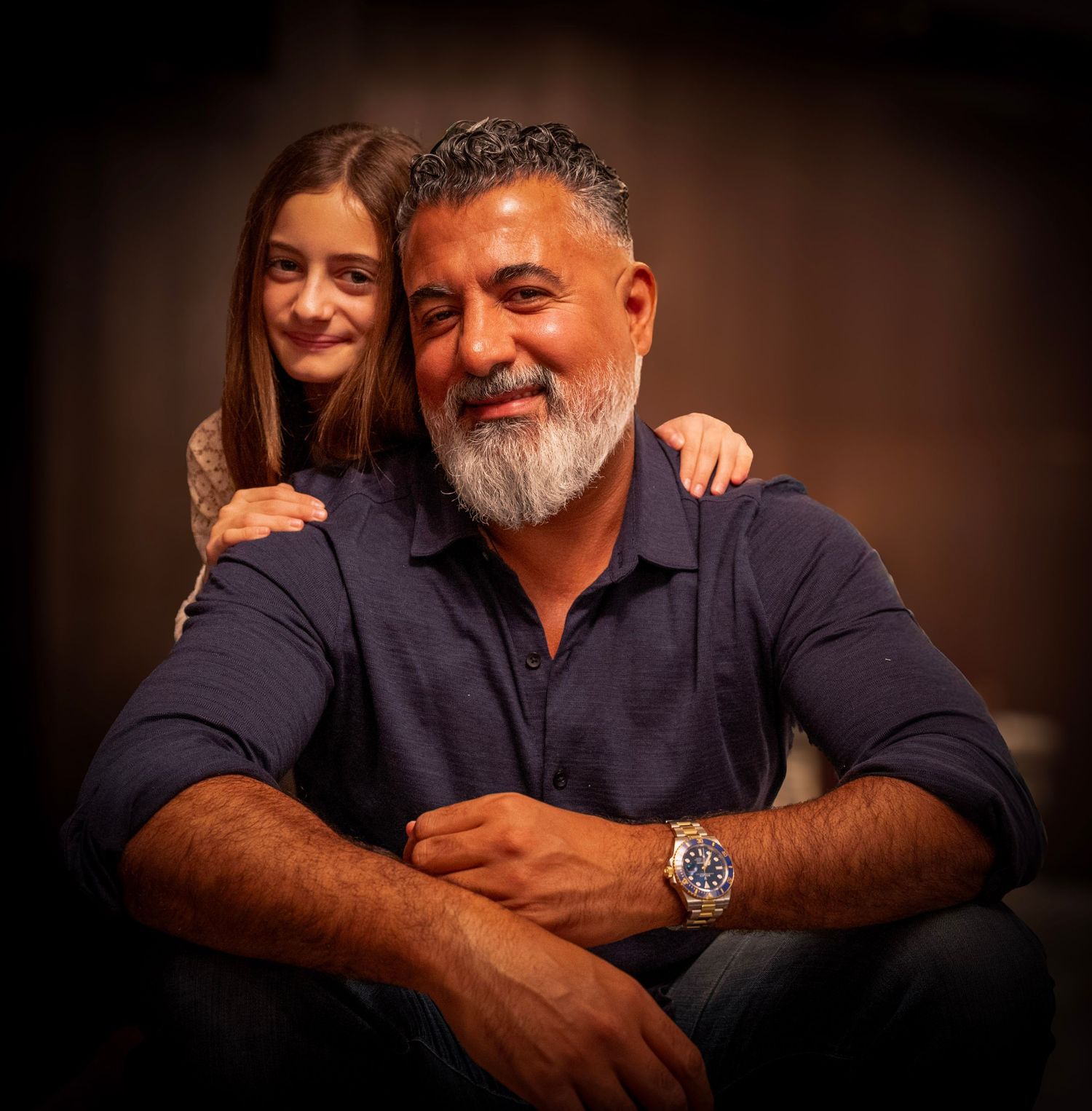 Portrait series showing a person in a navy shirt against dark background expressing different emotions and poses.