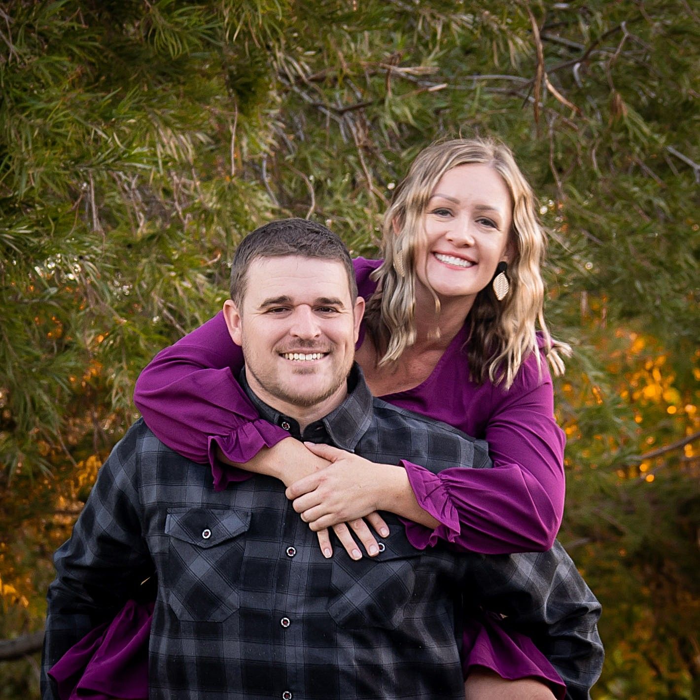 Joyful outdoor portrait session showing affectionate moments between a couple.
