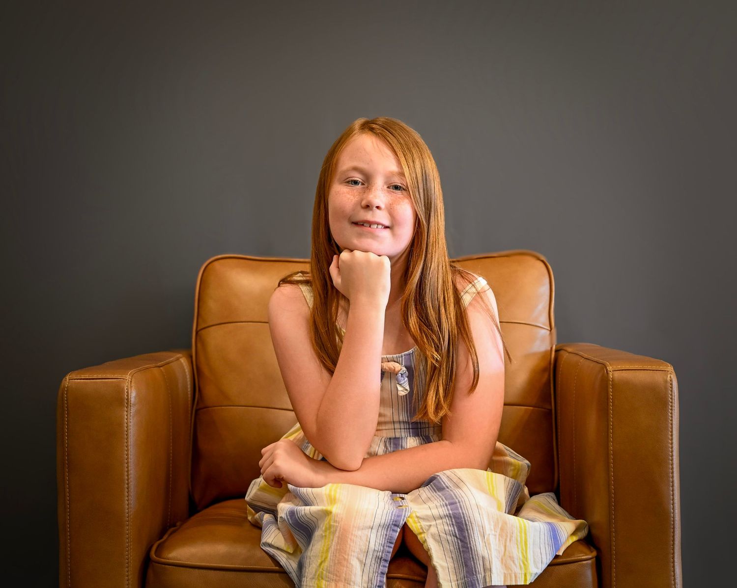 A relaxed lifestyle portrait series showing someone lounging on a brown leather couch.