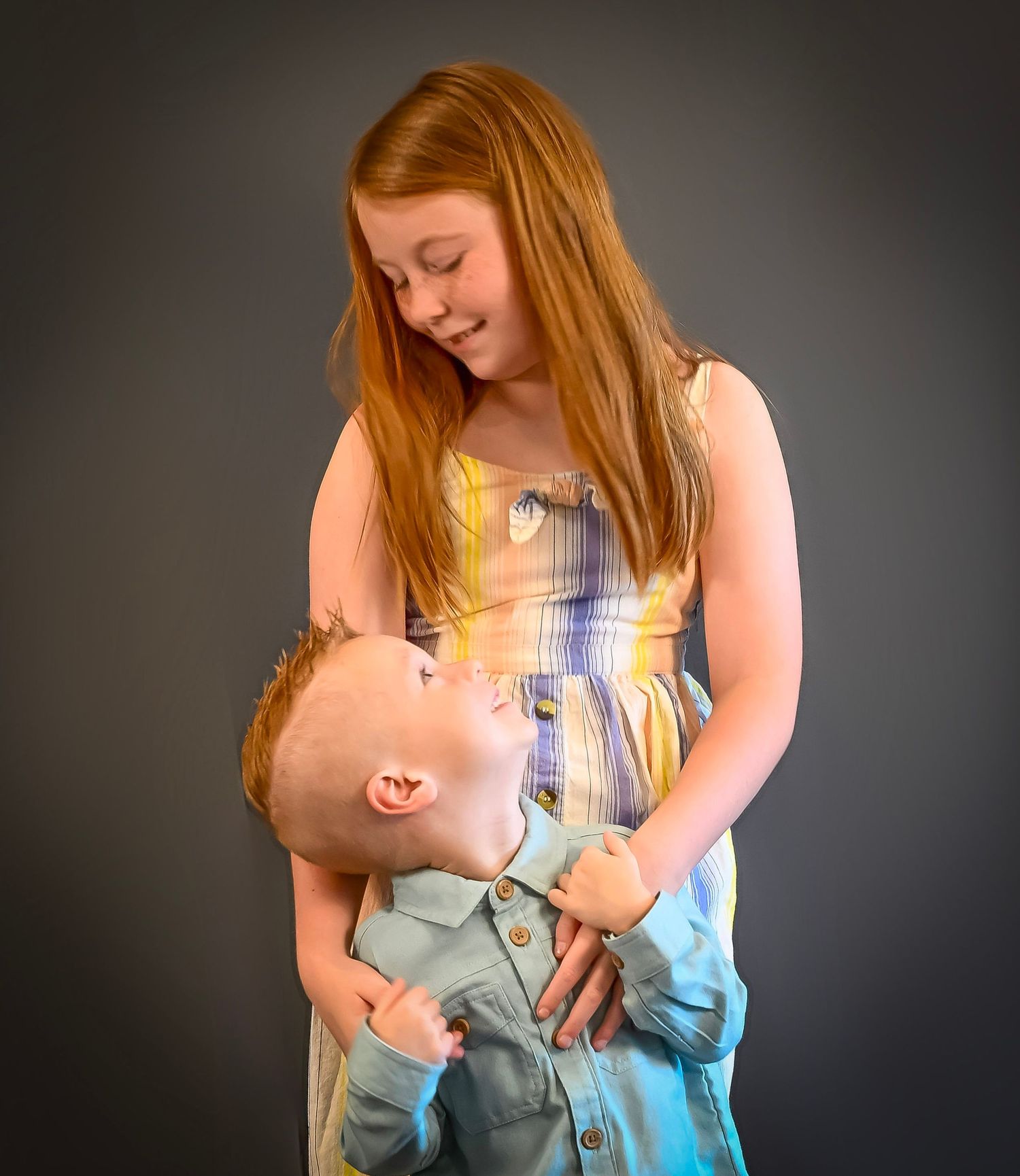 A series of intimate portrait shots showing tender moments between parent and baby against a dark background.
