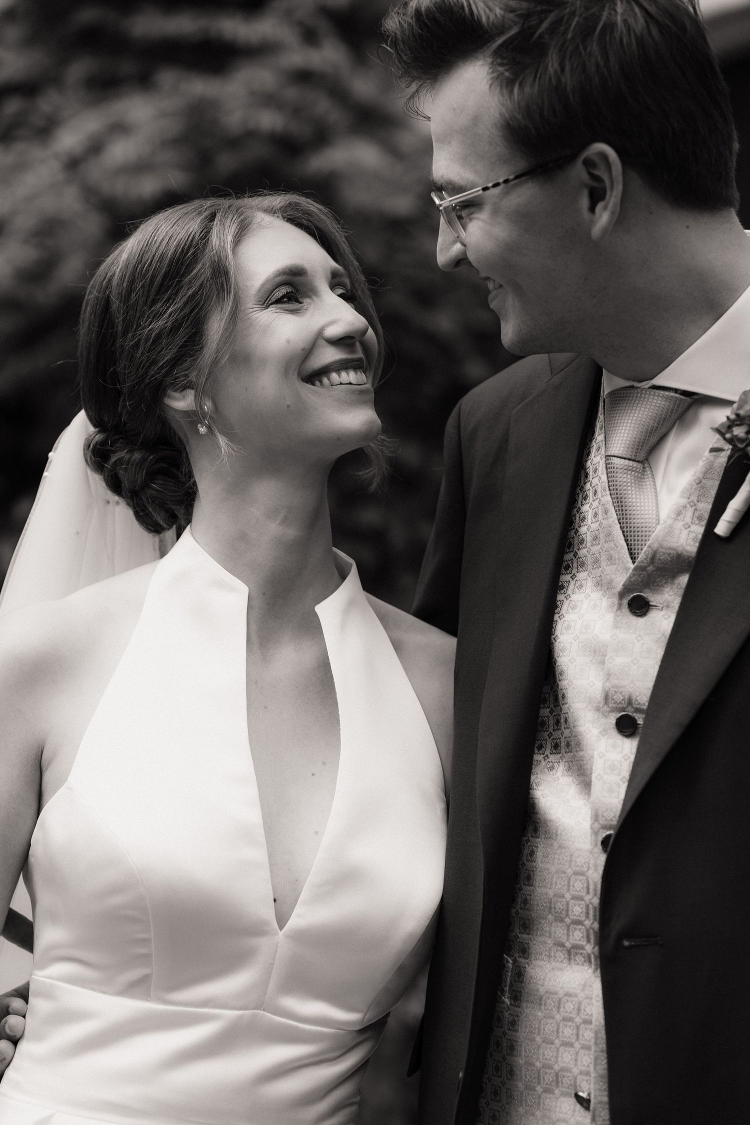 Black and white wedding portraits showing joyful expressions and intimate moments.