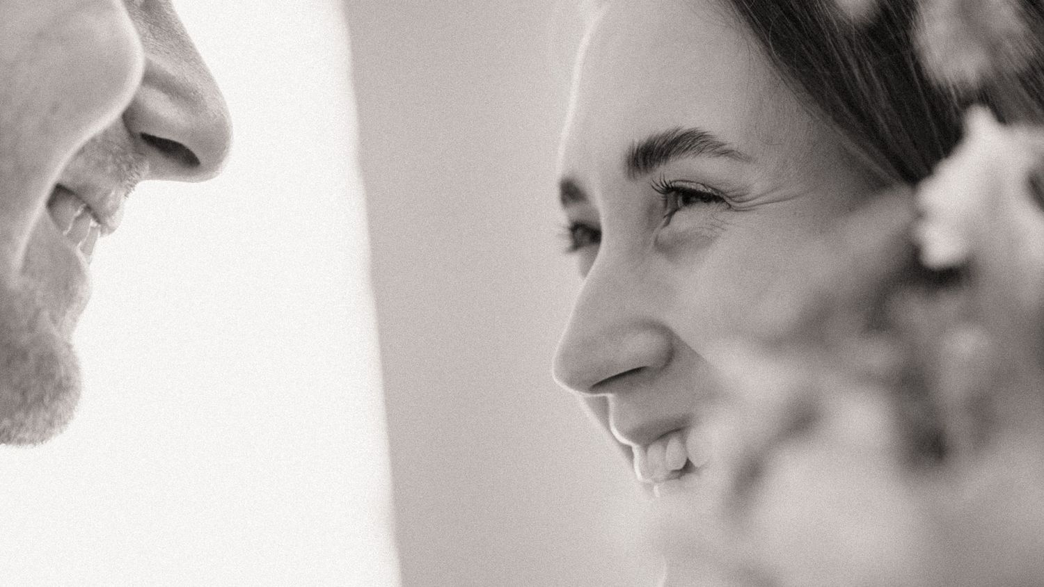 Close-up artistic black and white portrait showing joyful expressions.