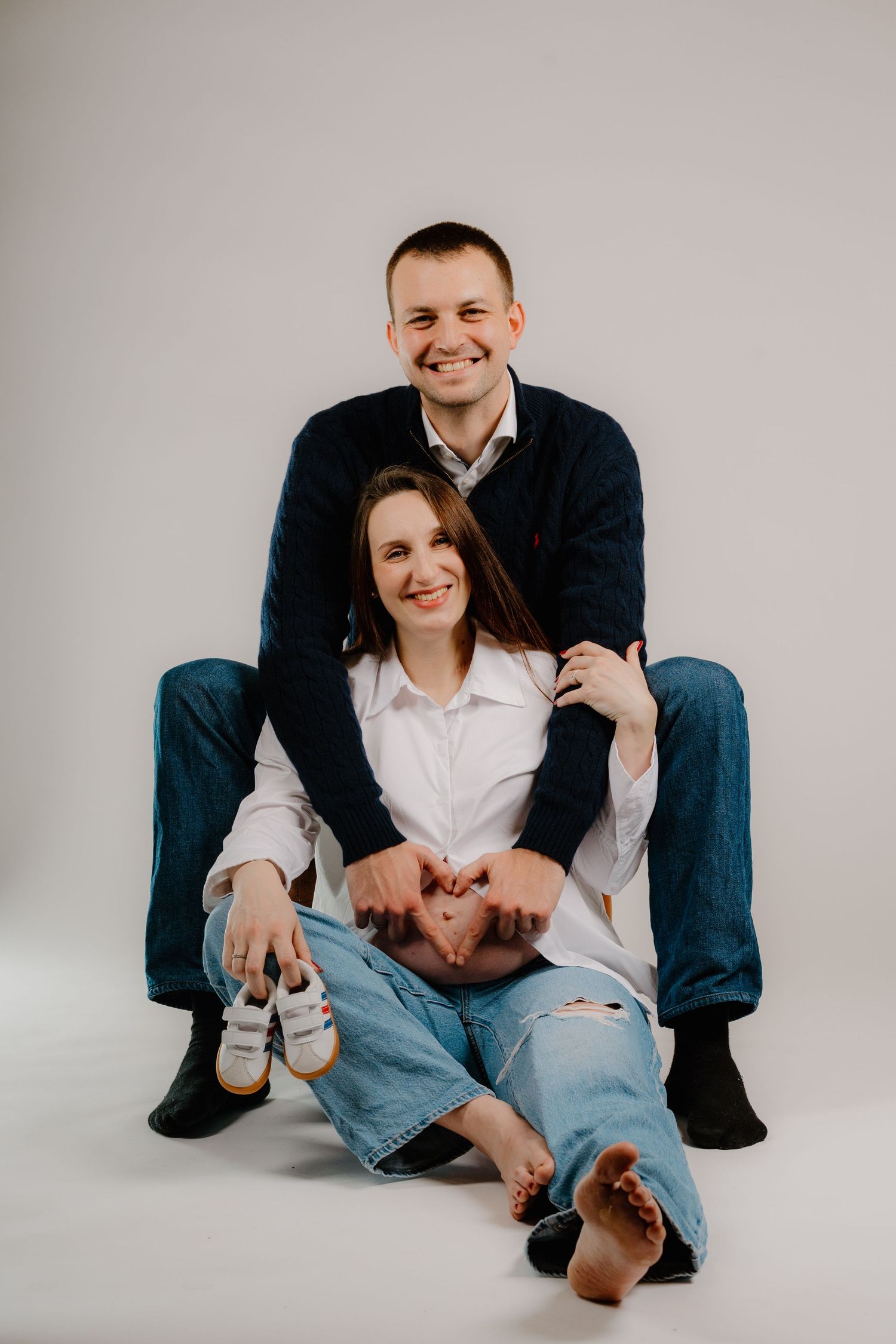 Casual studio portraits showing playful interactions on white background.
