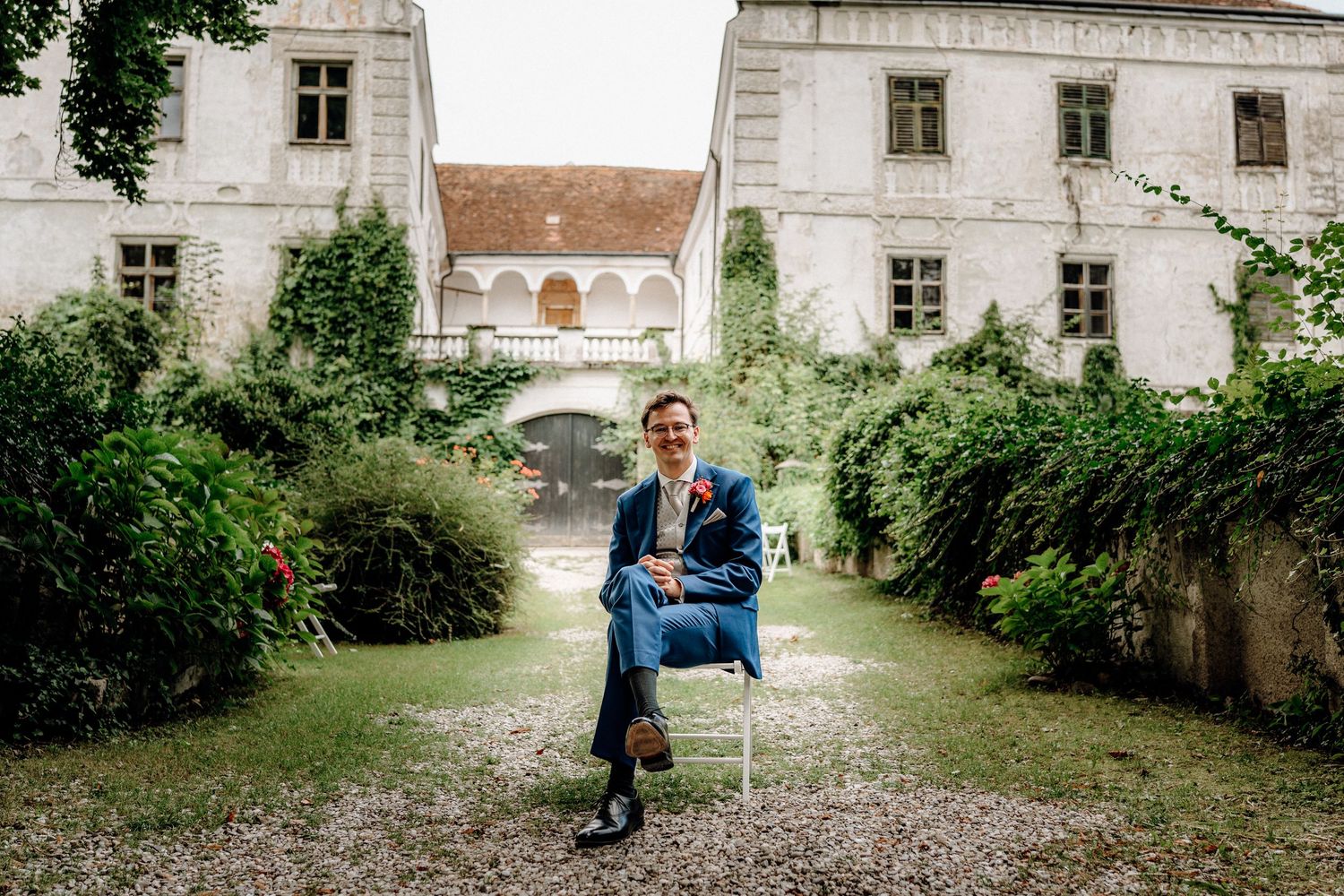 Series of wedding portraits taken in front of a historic white building with arched architecture.