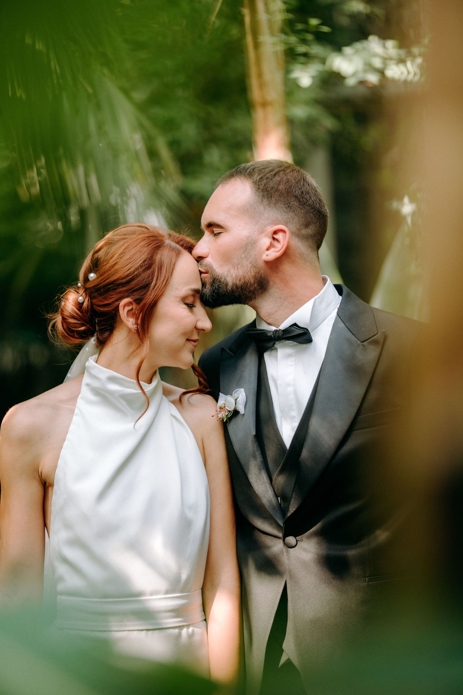 Romantic wedding portraits in a garden setting with soft natural lighting.