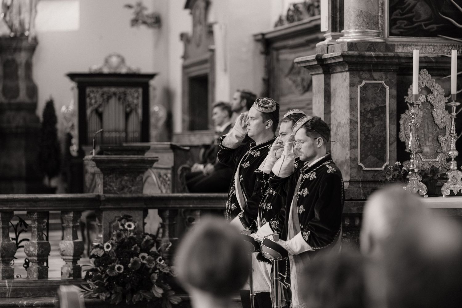 Black and white photograph of a wedding ceremony in a historic church with ornate architecture.