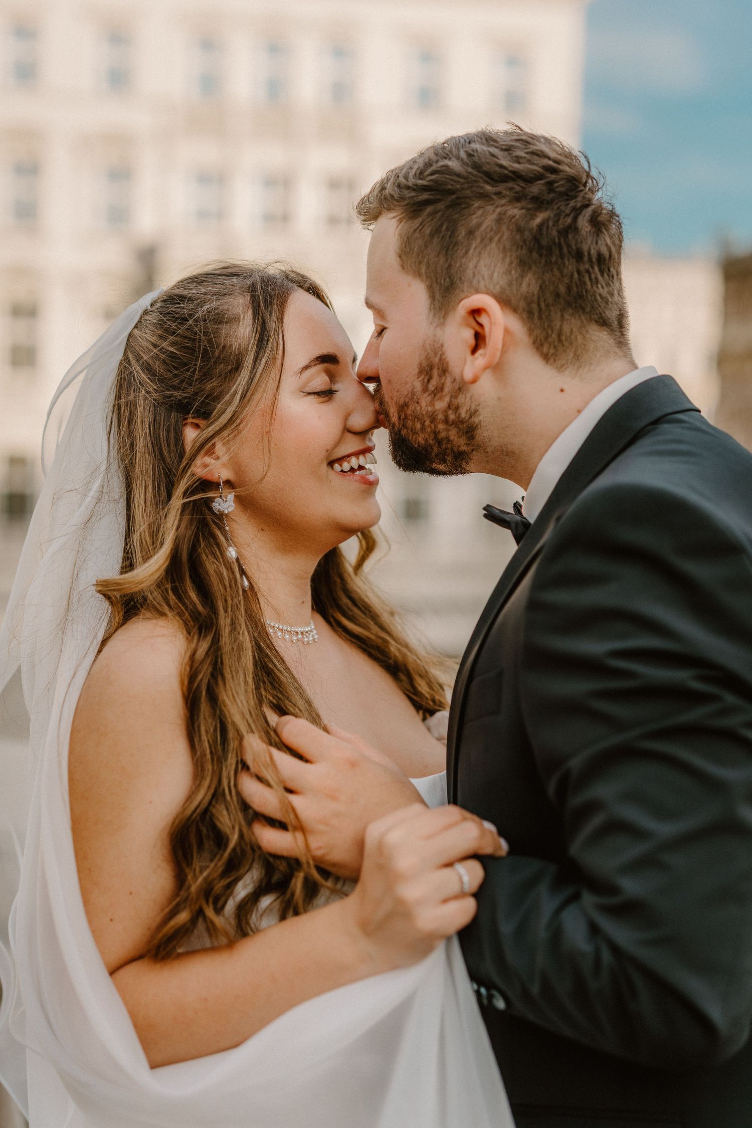 A romantic wedding couple shares intimate kisses in a sequence of four connected photos.