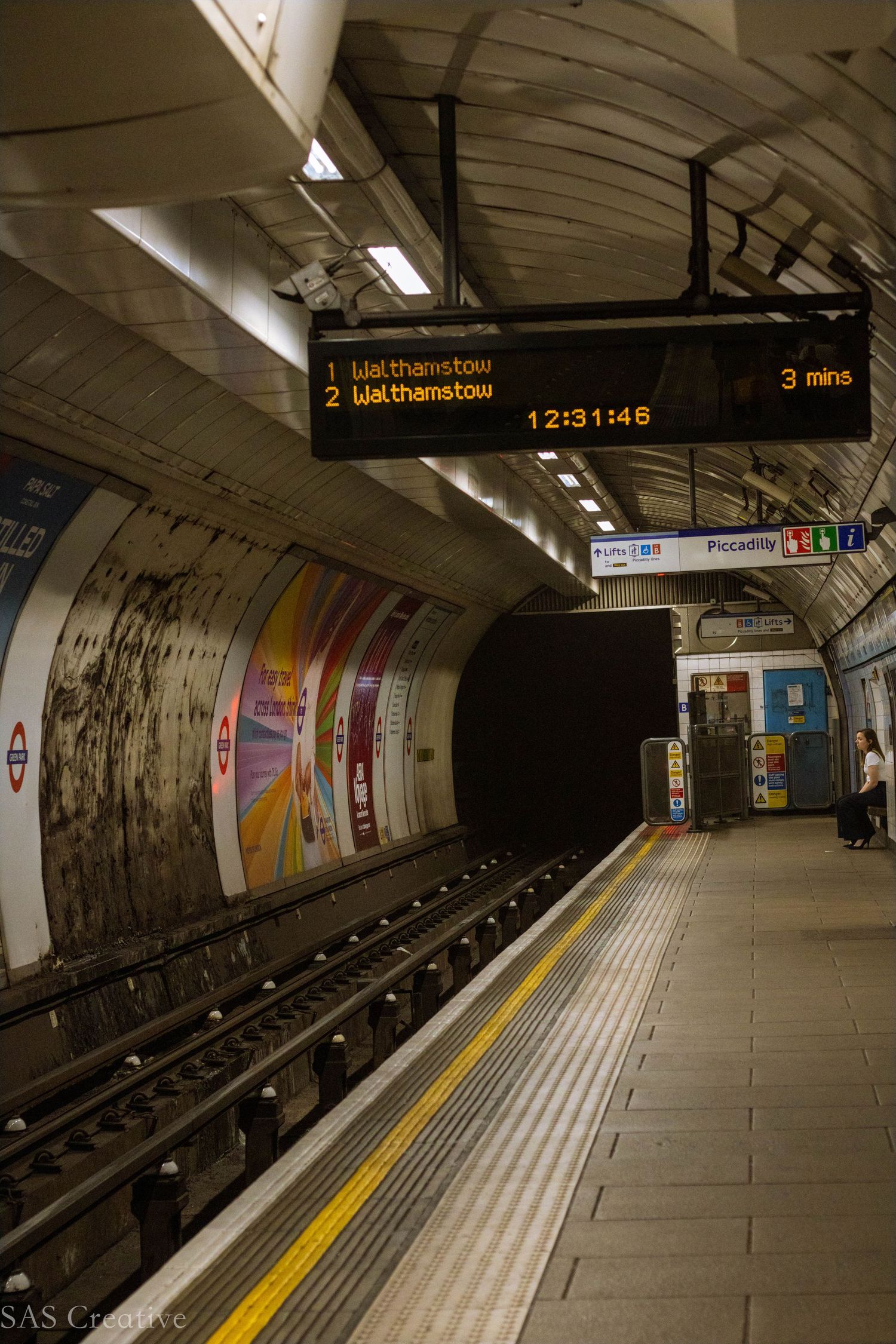 Empty London Underground Piccadilly line platform with digital departure board showing Walthamstow.