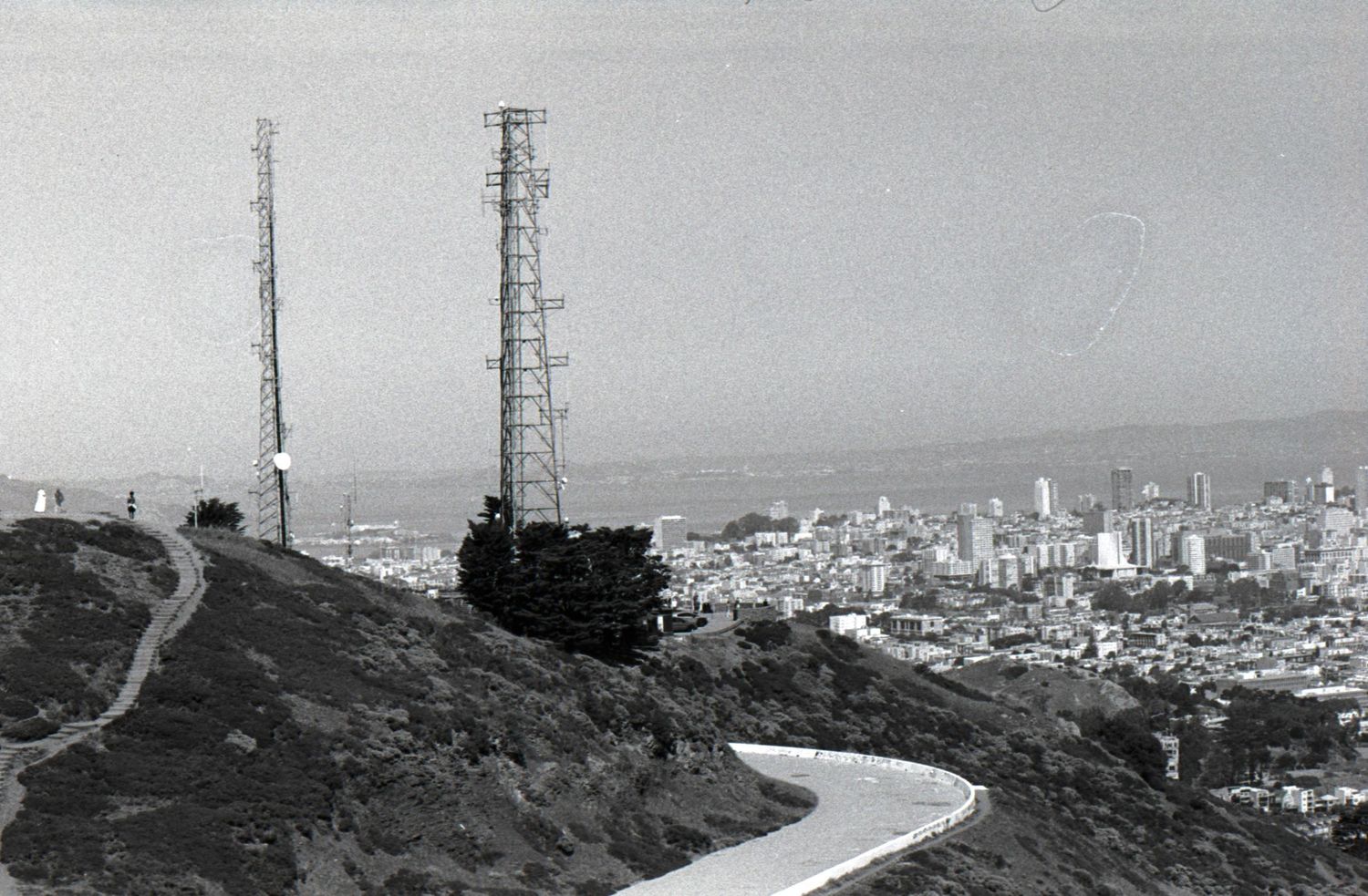 Black and white film photo of San Francisco skyline viewed from Twin Peaks with radio towers in foreground.