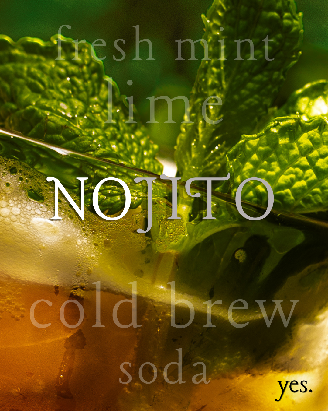 Nojito cold brew mocktail with fresh mint, lime, cold brew, and soda on lush green mint leaf background.
