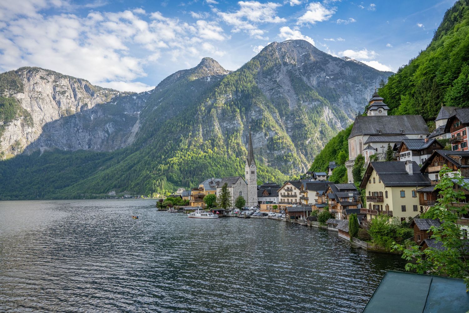 Picturesque village of Hallstatt nestled between mountains and lake in Austria with traditional Alpine architecture.
