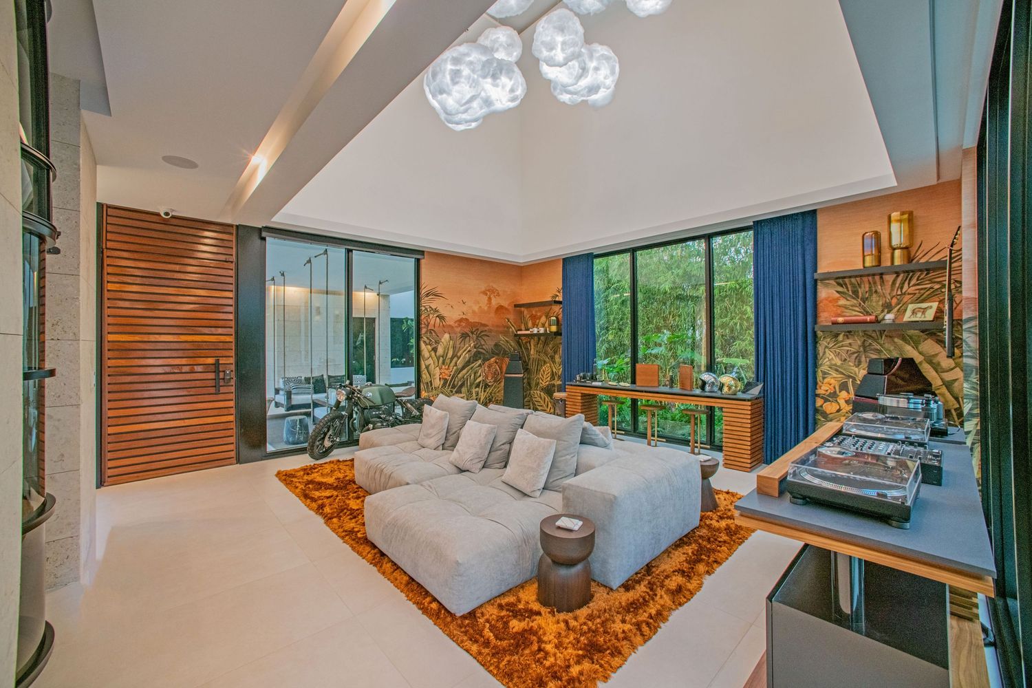 Modern luxury bedroom interior with panoramic windows, blue curtains, and wood accent wall features ambient lighting.