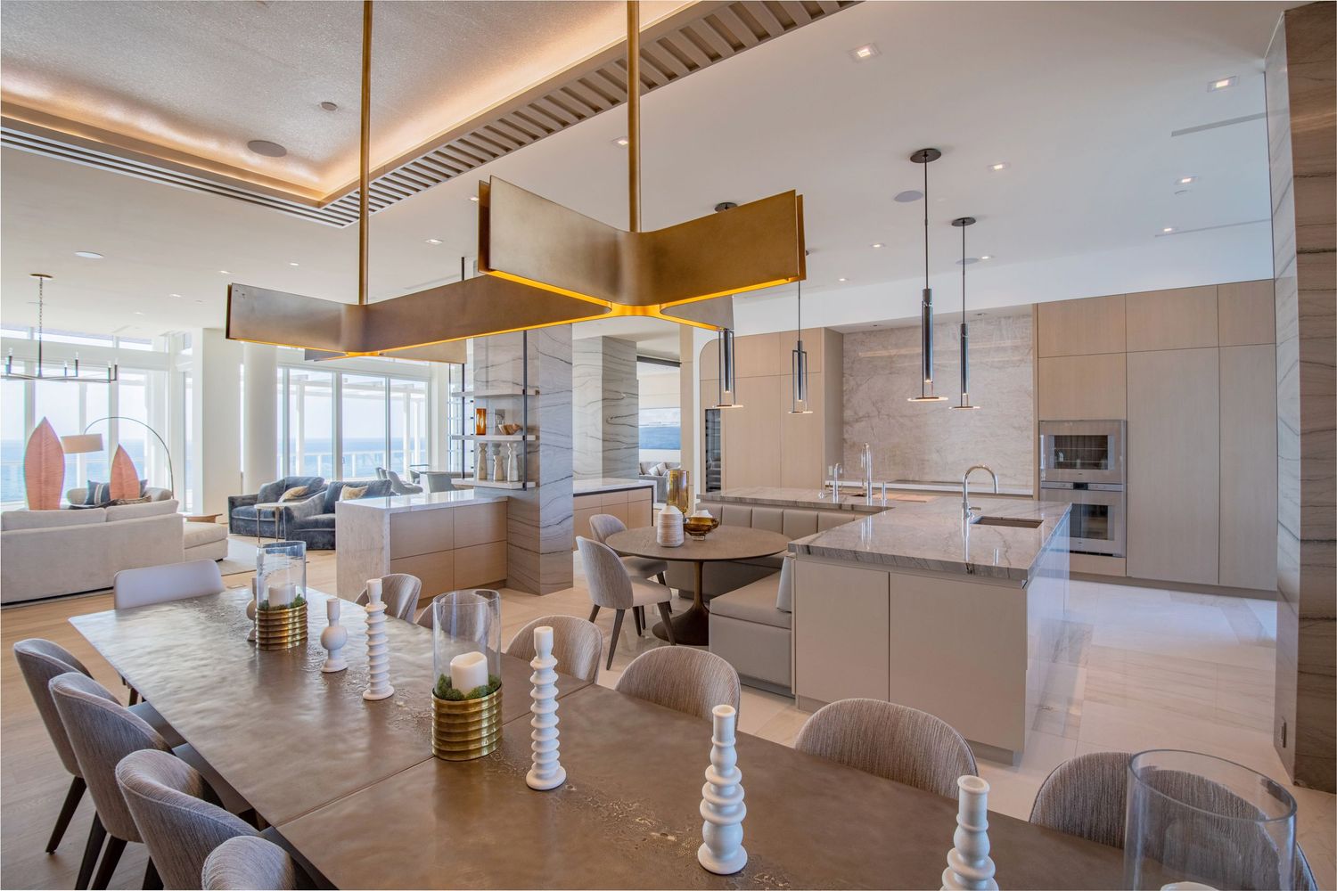 Modern open concept apartment interior with light wood floors, white walls, and floor-to-ceiling windows.