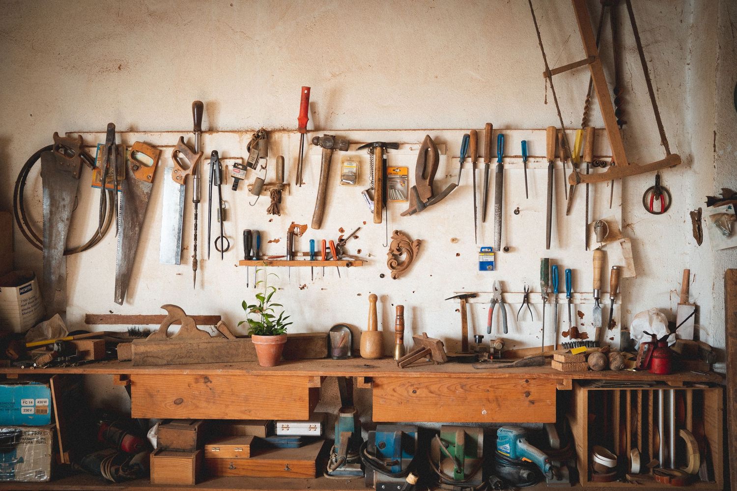 Organized vintage woodworking workshop wall displaying an array of traditional hand tools.