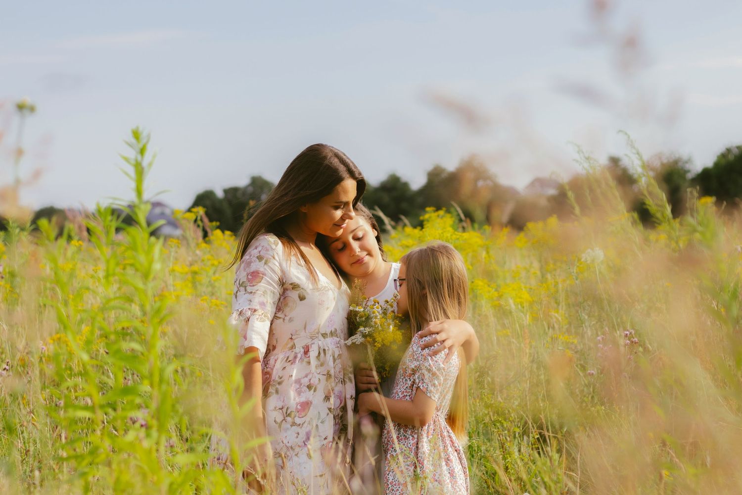 candid outdoor family portrait with mother and daughters in wildflower field in Ottawa - R&B AuraCapture